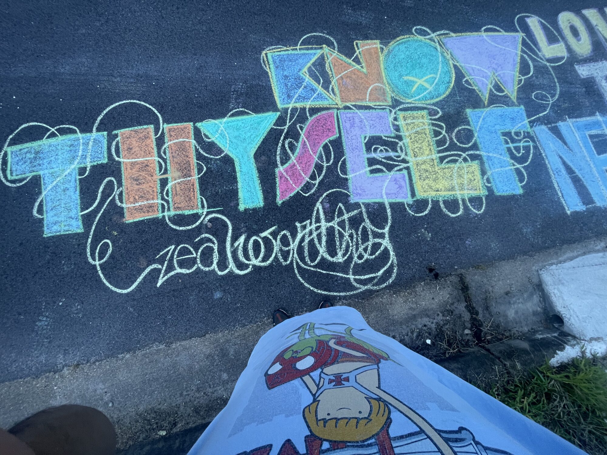 an image of a chalk drawing in a blocky font. the text reads "know thyself"
